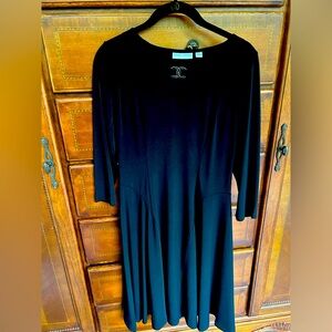 Susan Graver black mid length dress with polished silver trim at neck